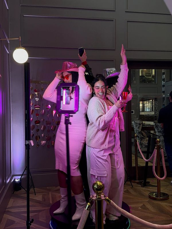 Three friends dressed in festive attire enjoying a lively party.