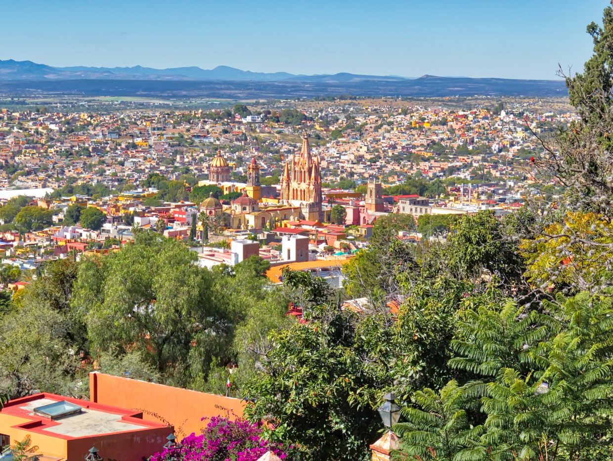 Scenic city panorama with cathedral and greenery.