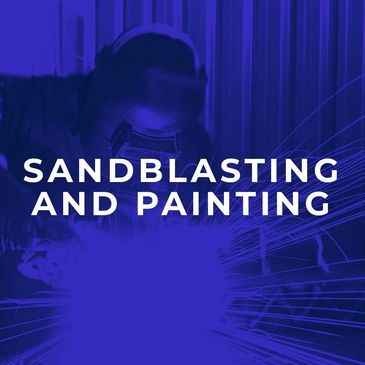 Worker performing sandblasting or welding with sparks flying.