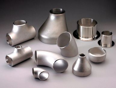 Various stainless steel pipe fittings arranged on a surface.
