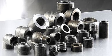 A collection of metal pipe fittings and connectors.