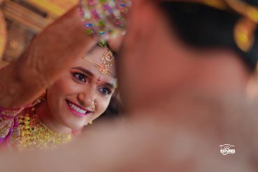 A bride smiling during a wedding ceremony.