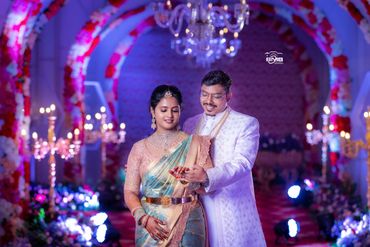 Happy couple in traditional attire during a celebration.