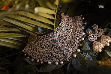 Intricate gold necklace with matching earrings.