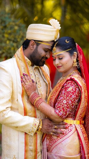 Traditional Indian couple in wedding attire sharing a moment.