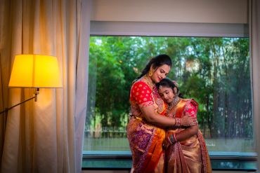 Mother and daughter sharing a warm hug indoors.