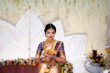 A woman in traditional Indian attire with jewelry.