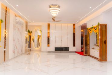 Modern living room with marble flooring and yellow floral decorations.