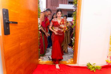 A woman dressed in red performing an entrance ritual.