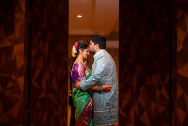 Couple in traditional attire sharing a tender moment.