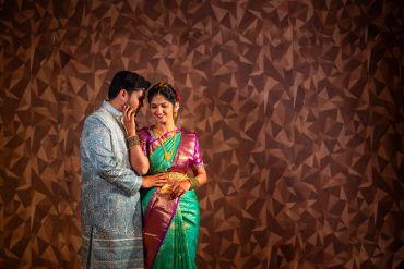 Couple in traditional attire sharing a tender moment.
