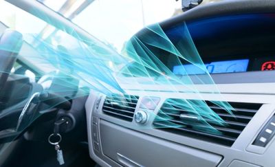 Airflow from car air conditioning vent inside a vehicle cabin.