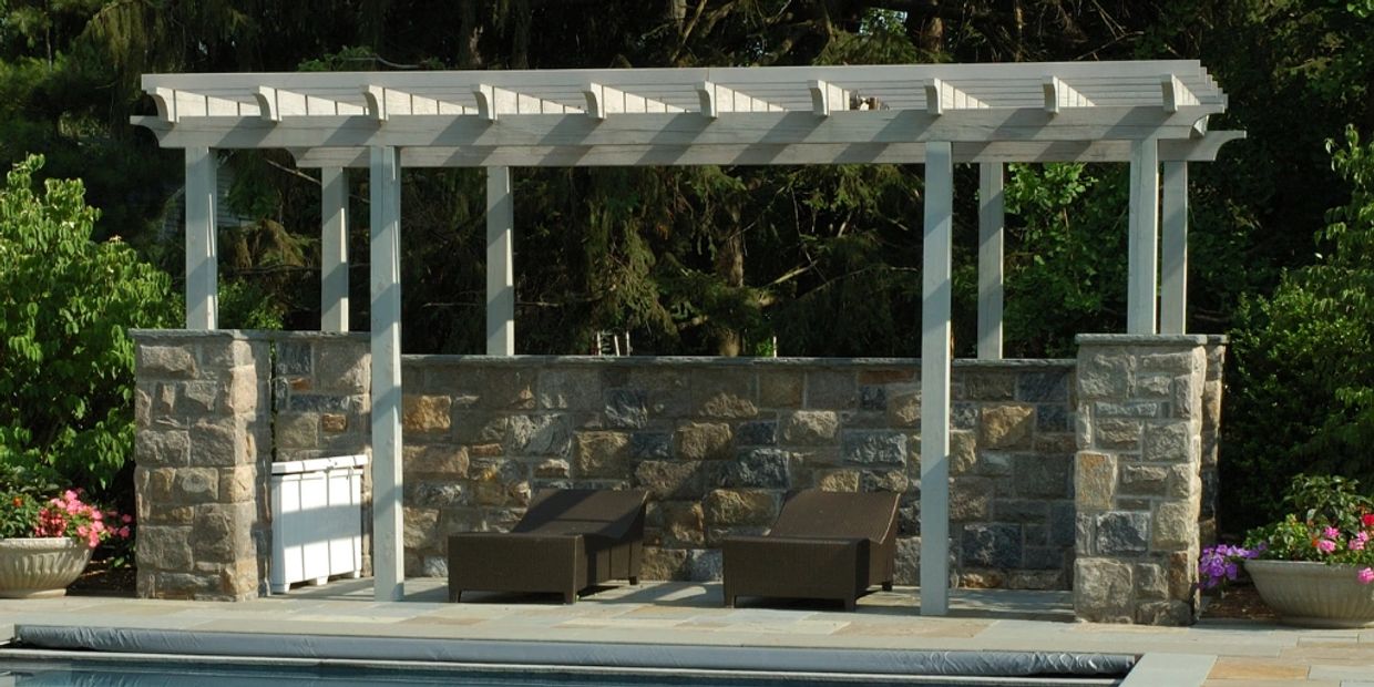 Custom black aluminum pergola with clean lines, creating a stylish outdoor lounge area.