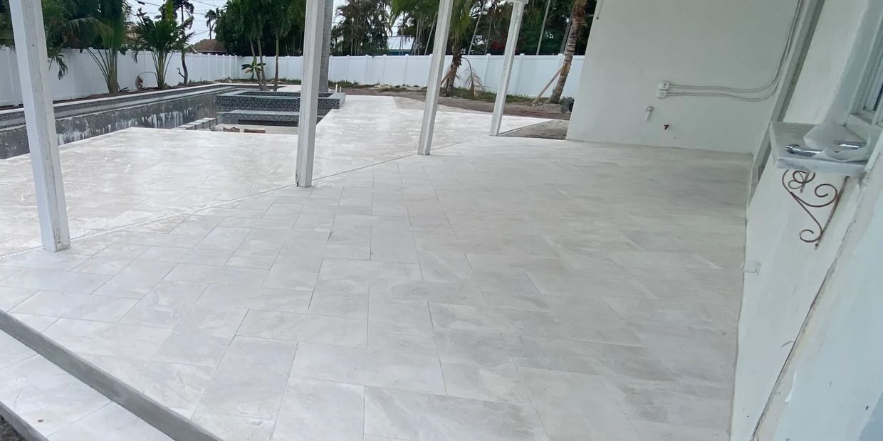 Elegant travertine paver patio with warm earth tones, professionally installed for a smooth, high-en