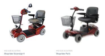 Two red mobility scooters with comfortable seats and front baskets.