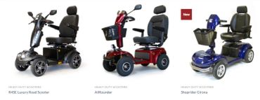 Three luxury mobility scooters in black, red, and blue colors.