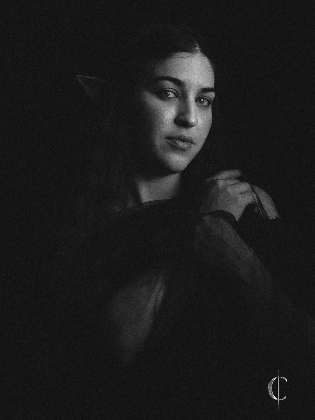 Black and white portrait of a woman with a soft expression.