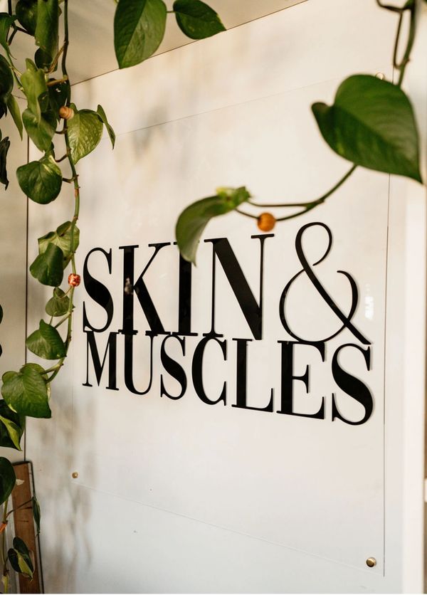 Skin & Muscles logo behind the front counter
