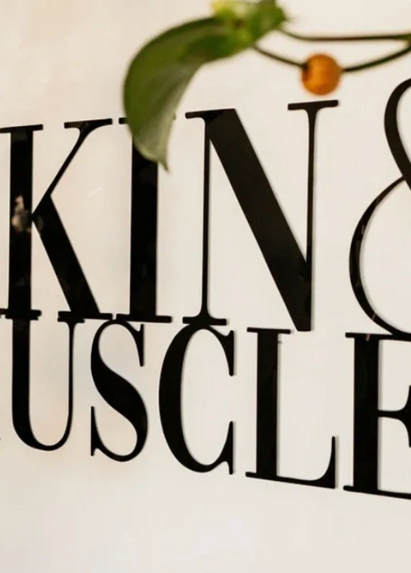 Skin & Muscles logo behind the front counter