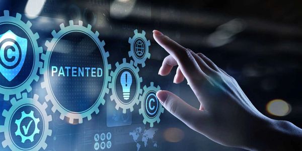 Hand interacting with digital icons related to patents and copyrights.