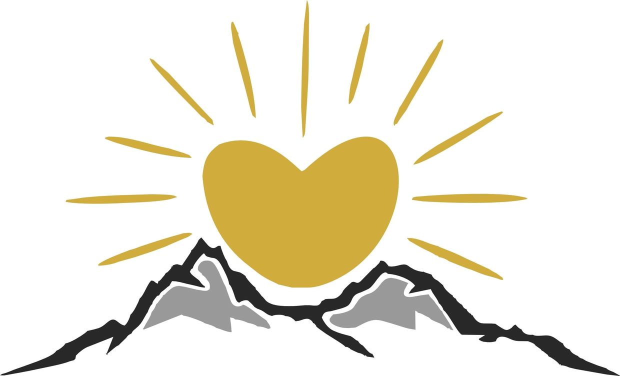 Golden heart shining over black and gray mountain peaks with rays.