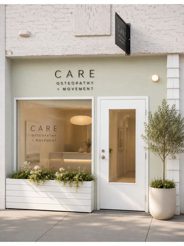 Modern osteopathy clinic exterior with clean white design and greenery.