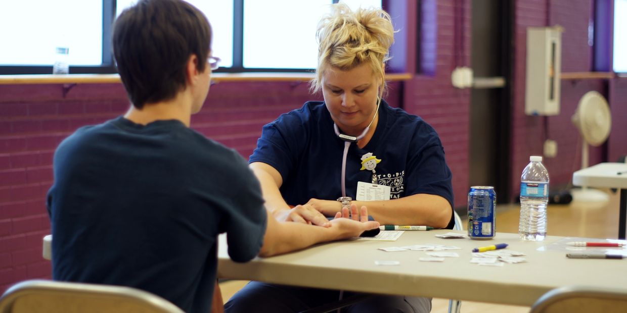 Photo of a TOPS volunteer performing part of a TOPS physical