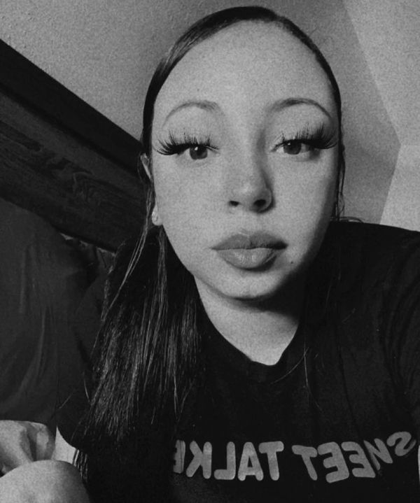Black and white selfie of a woman with long eyelashes.