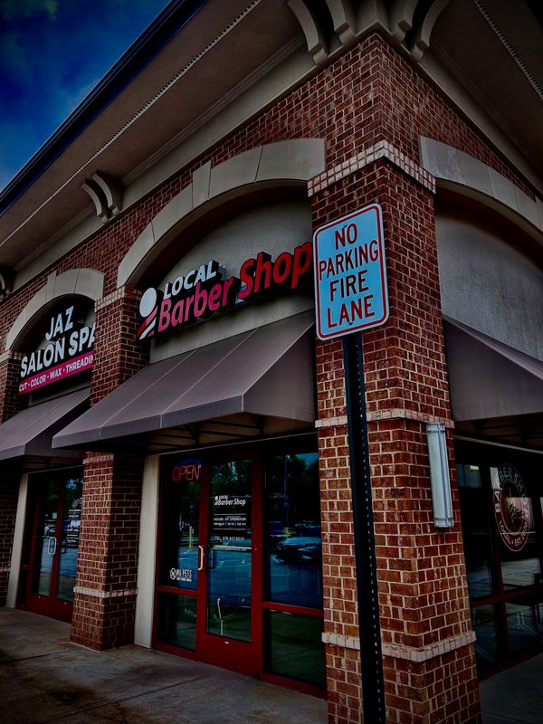 Clean windows reveal the shop inside, while the familiar red-and-white pole shines the street