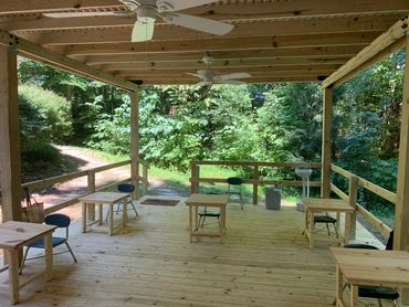 Handmade desks, socially distanced in Waldorf classroom set in forestry setting 