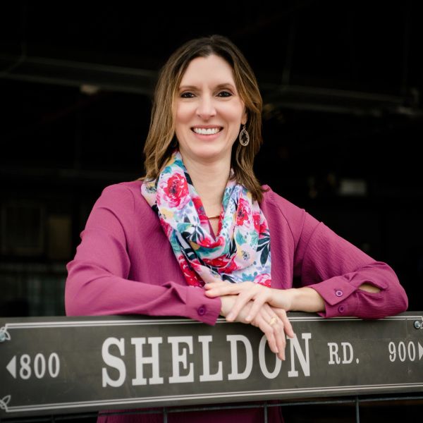 Professional headshot of female consulting firm founder, appearing confident, approachable, and trus