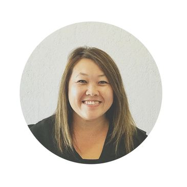 Smiling woman with straight hair against a plain white background.