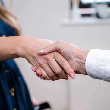 Victoria Lacey, BABCP-accredited CBT therapist in Wirral Shaking hands with an Adult Client