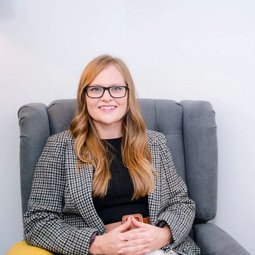 Victoria Lacey Private Therapist sitting in a chair in the GETCBT Wirral Clinic 