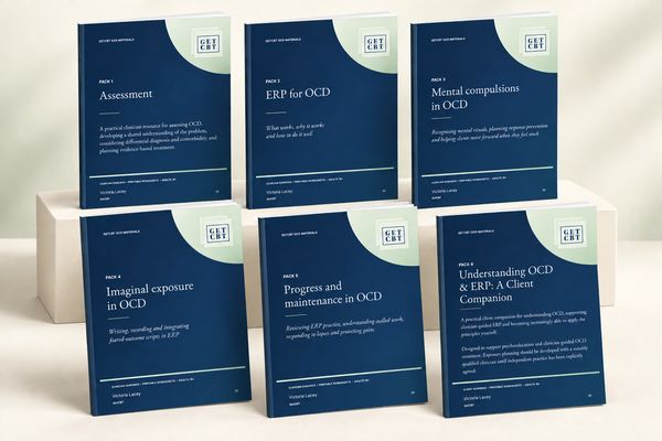 Set of booklets on OCD and ERP therapy arranged on platforms.