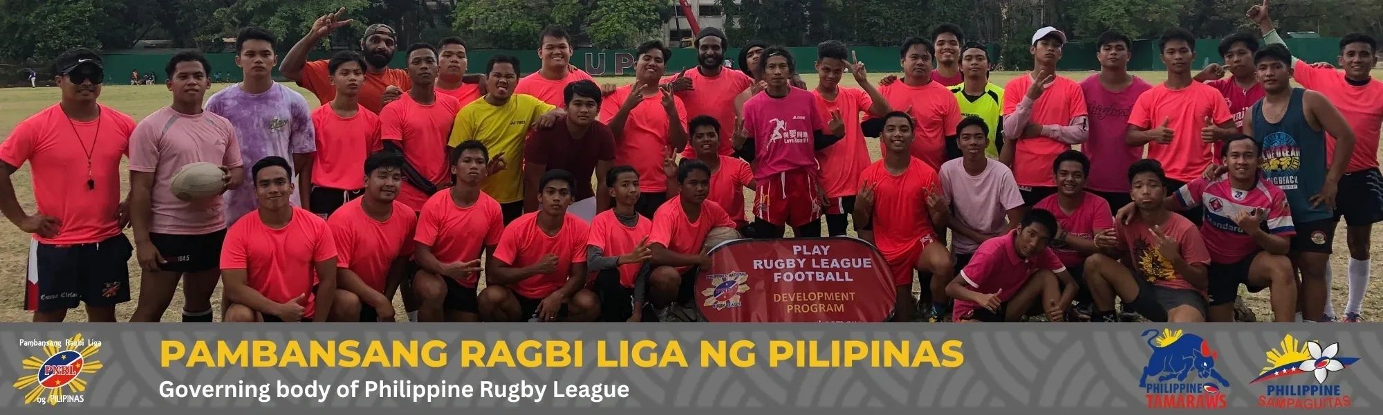 Large group of Philippine rugby players posing for a team photo on a field.