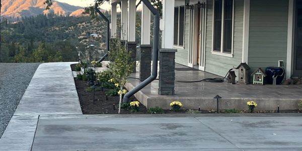 Modern porch with flowerbed and mountain view.