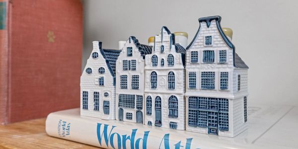 Miniature ceramic houses on a book.