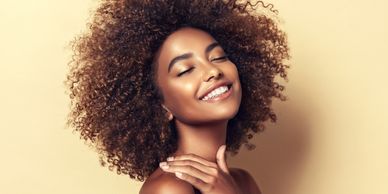 A YOUNG BLACK LADY WITH AN AFFRO HAIRSTYLE
