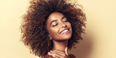 A YOUNG BLACK LADY WITH AN AFFRO HAIRSTYLE