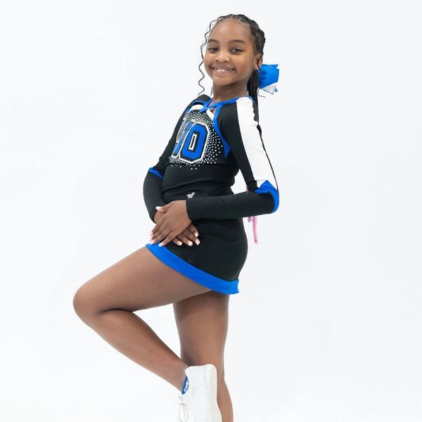 Young cheerleader posing in uniform.