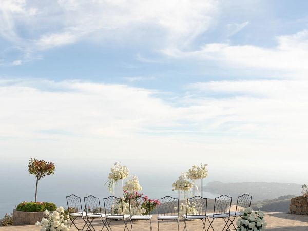Outdoor wedding setup with ocean view.