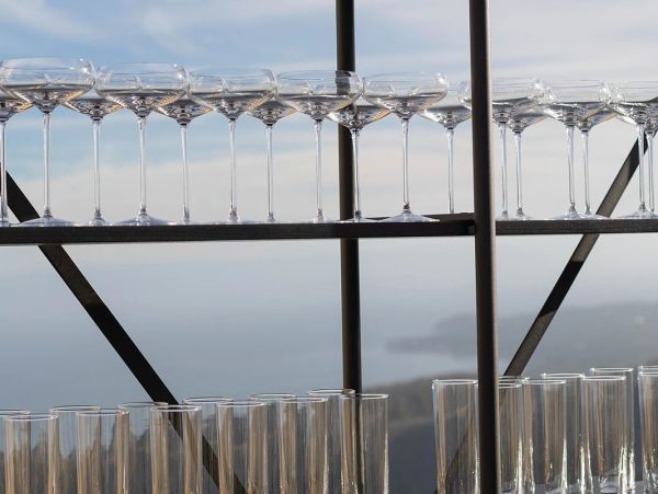 Empty glassware arranged on a shelf by the window.