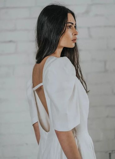 Woman in a white dress with open back
