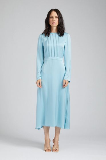 Woman in a light blue long-sleeve dress.