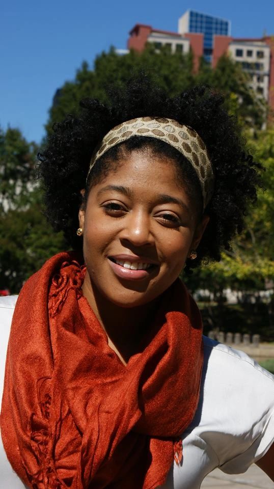 African-American woman wearing a fabric, satin-lined headband.