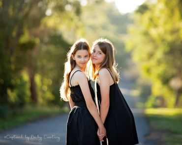 Two girls with tree background
