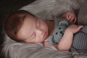 Newborn with grey teddy