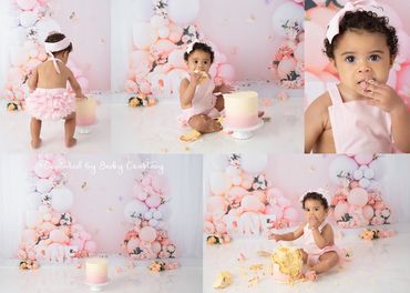 Little 1 year old girl smashes and eats cake, dressed in a pink romper, stunning floral pink and whi