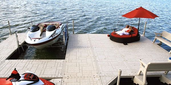 floating dock with mechanical boat lift and couple under umbrella